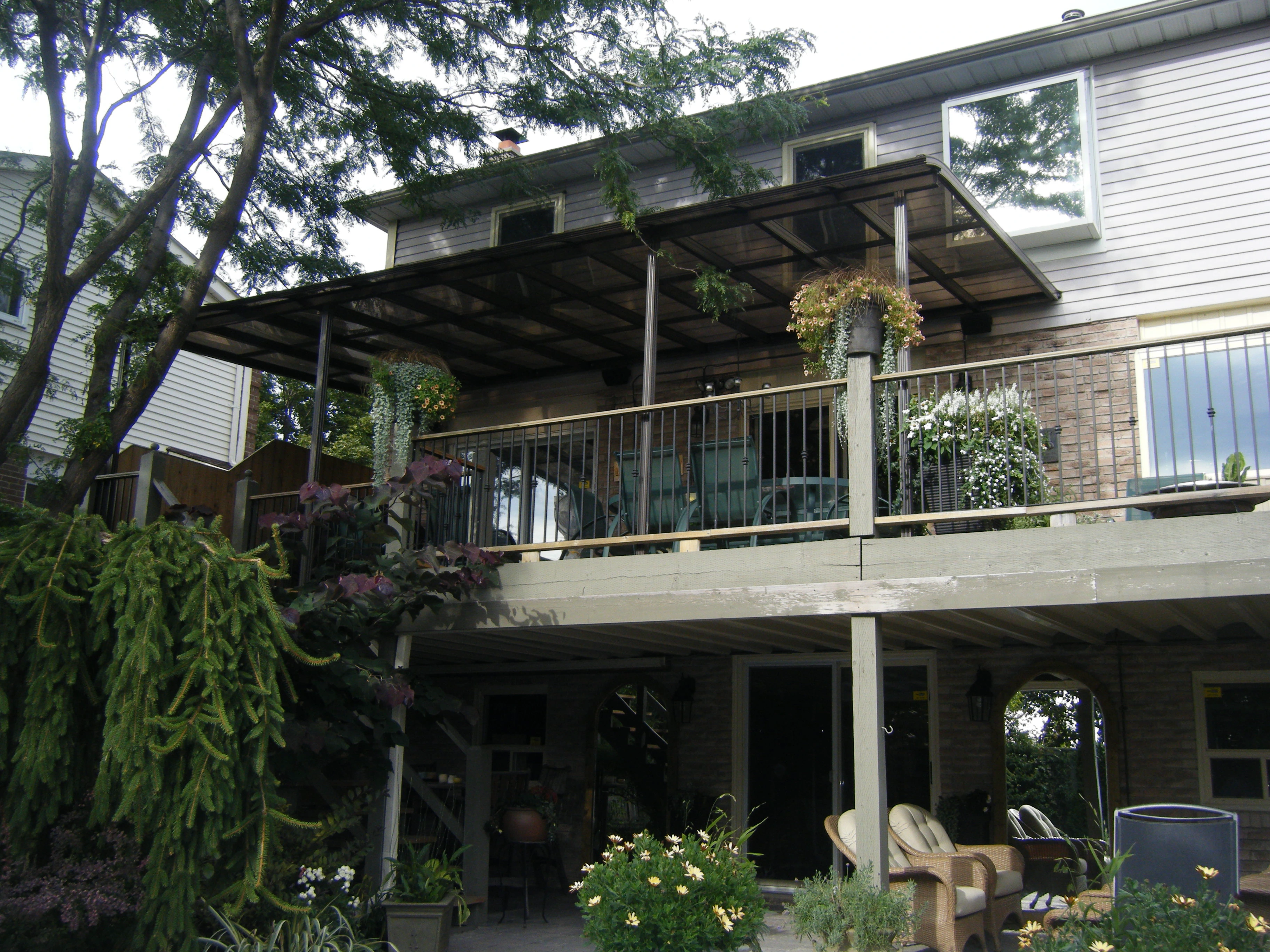 Dark-roof patio cover over a landscaped deck